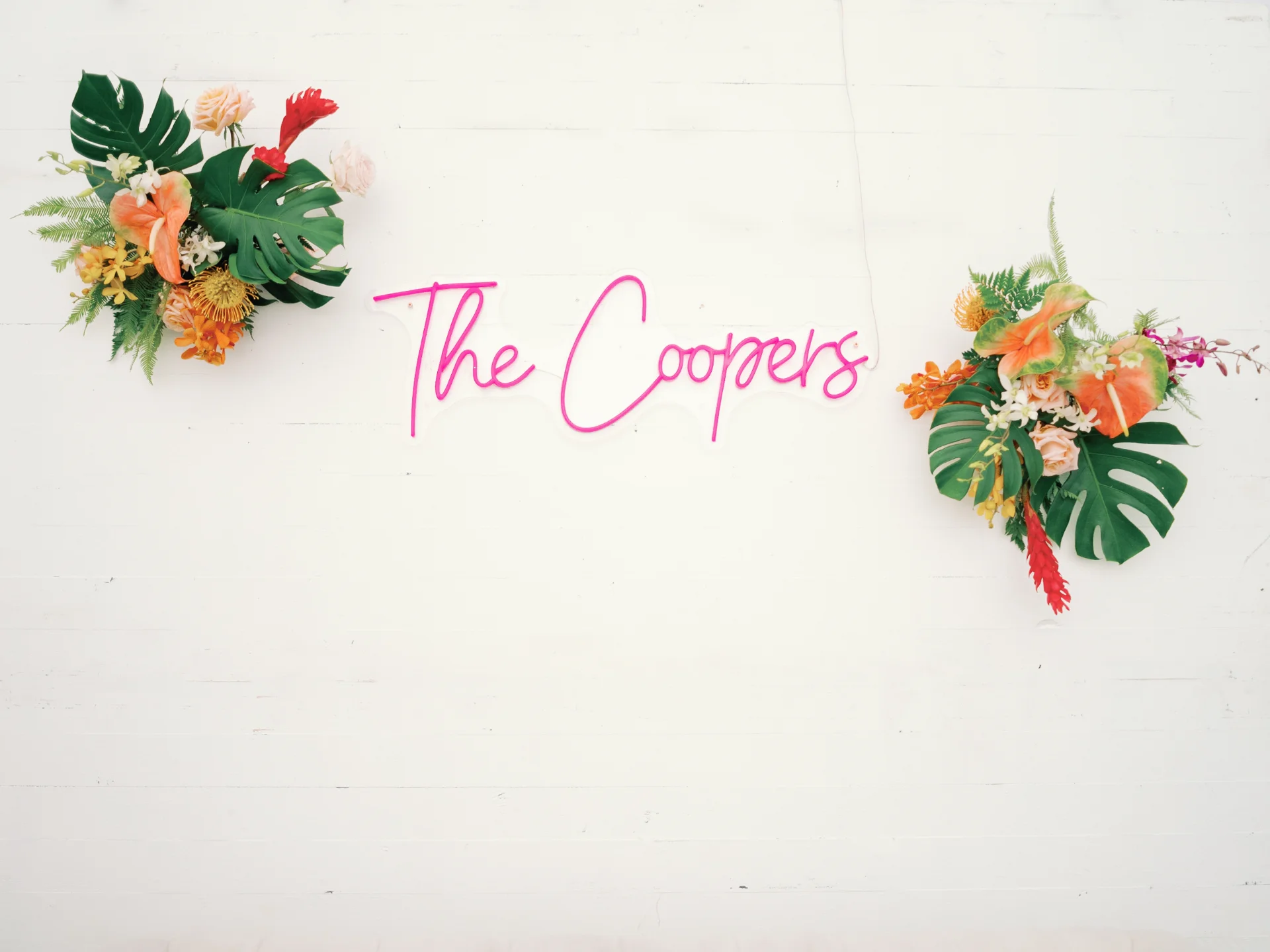 Tropical floral arrangements with vibrant anthuriums and greenery beside neon signage at Loulu Palms, Oʻahu wedding. — Wedding Event Oahu Hawaii Florals Flowers Florist Creative Concepts by Jeff Alencastre