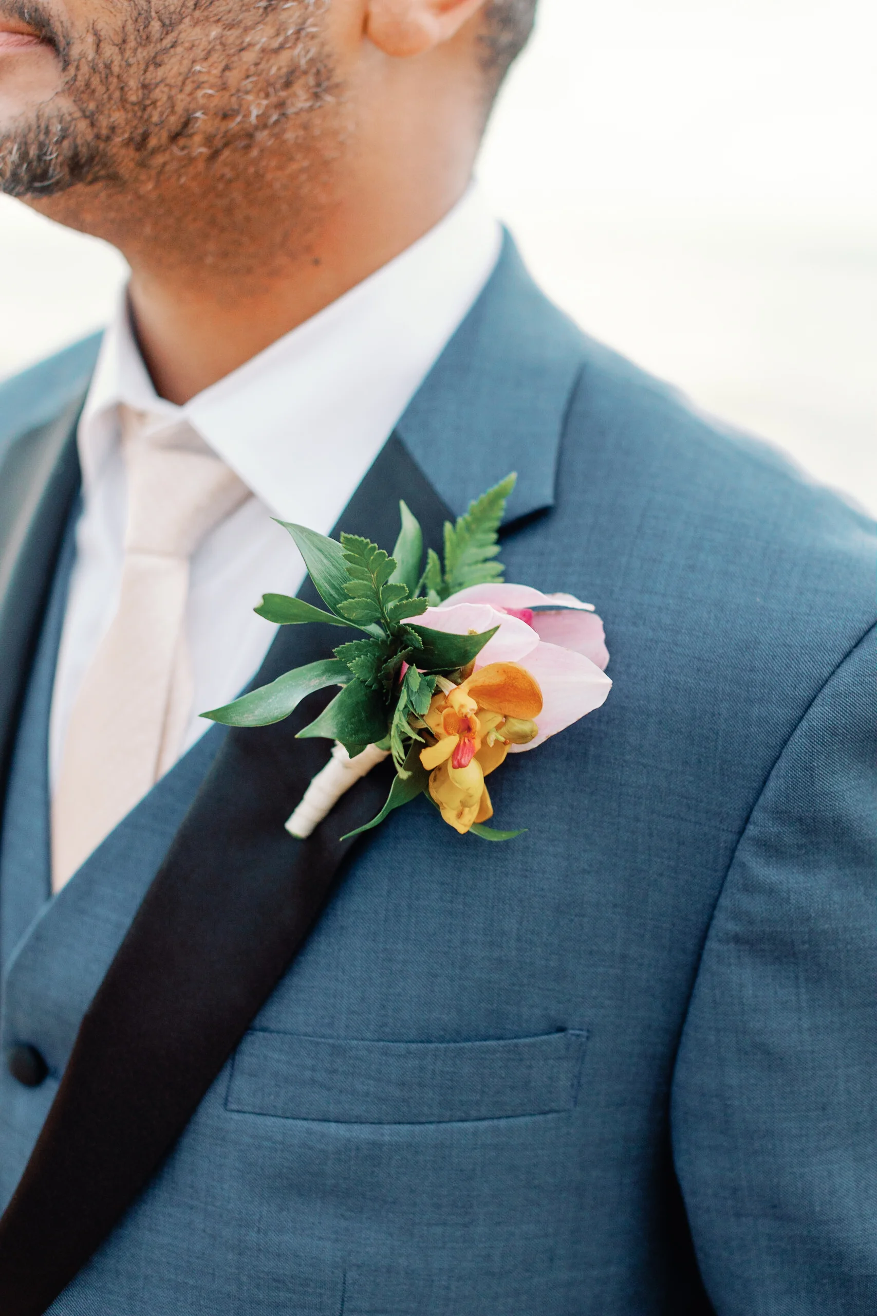 Groom in blue suit with pink and yellow orchid boutonniere, Loulu Palms, Oʻahu wedding — Wedding Event Oahu Hawaii Florals Flowers Florist Creative Concepts by Jeff Alencastre