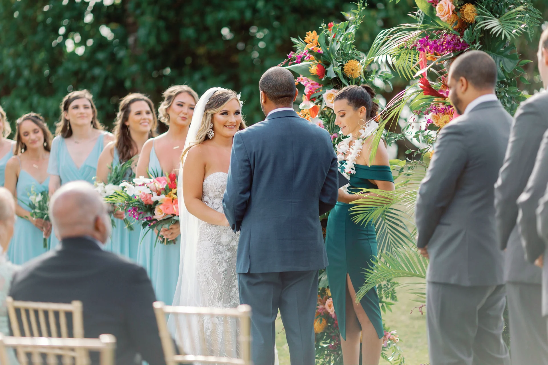 Bride and groom at outdoor ceremony with tropical floral arch at Loulu Palms, Oʻahu, surrounded by wedding party. — Wedding Event Oahu Hawaii Florals Flowers Florist Creative Concepts by Jeff Alencastre