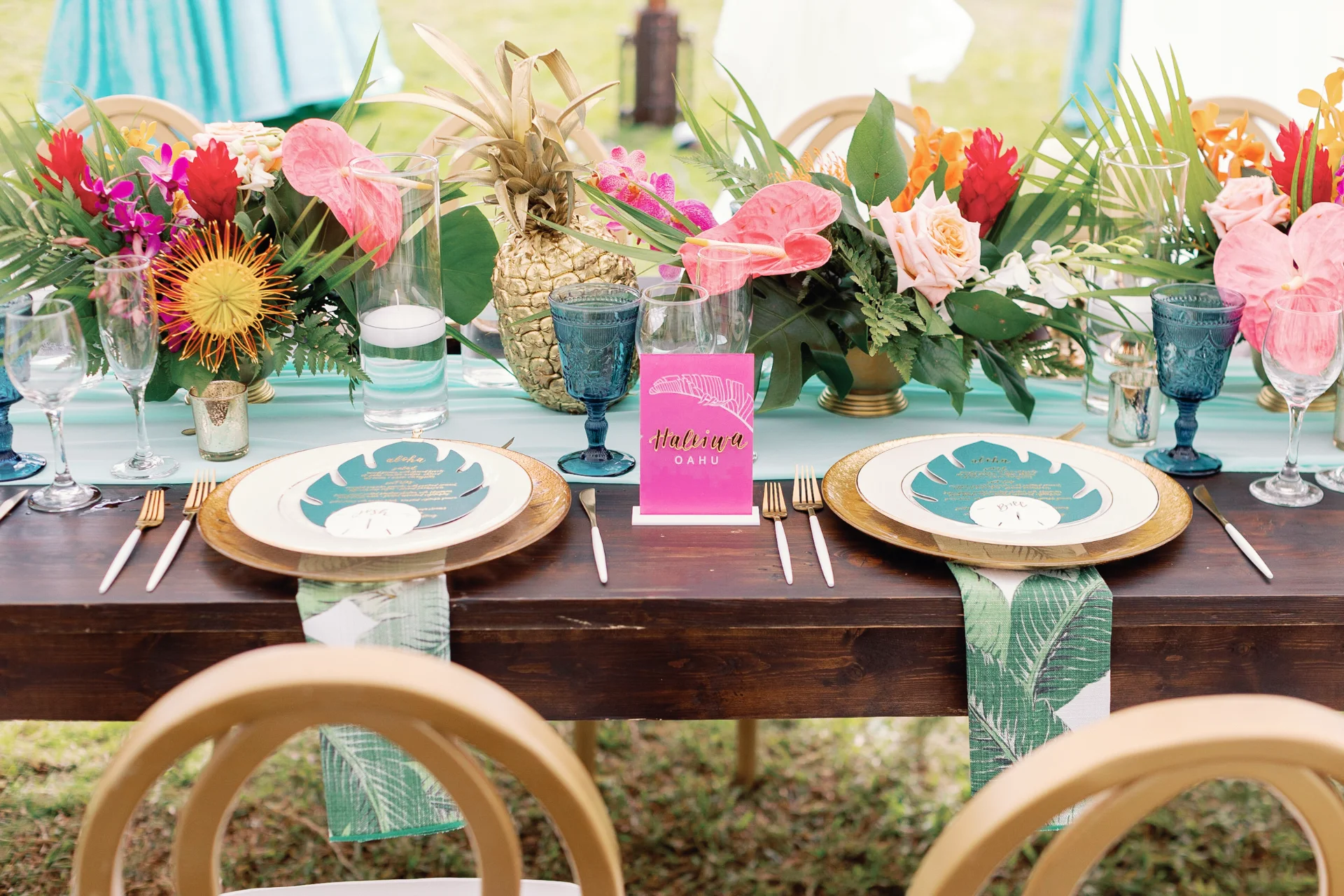 Tropical wedding table setting at Loulu Palms, Oʻahu with colorful floral centerpieces, pineapple decor, and elegant dishware. — Wedding Event Oahu Hawaii Florals Flowers Florist Creative Concepts by Jeff Alencastre
