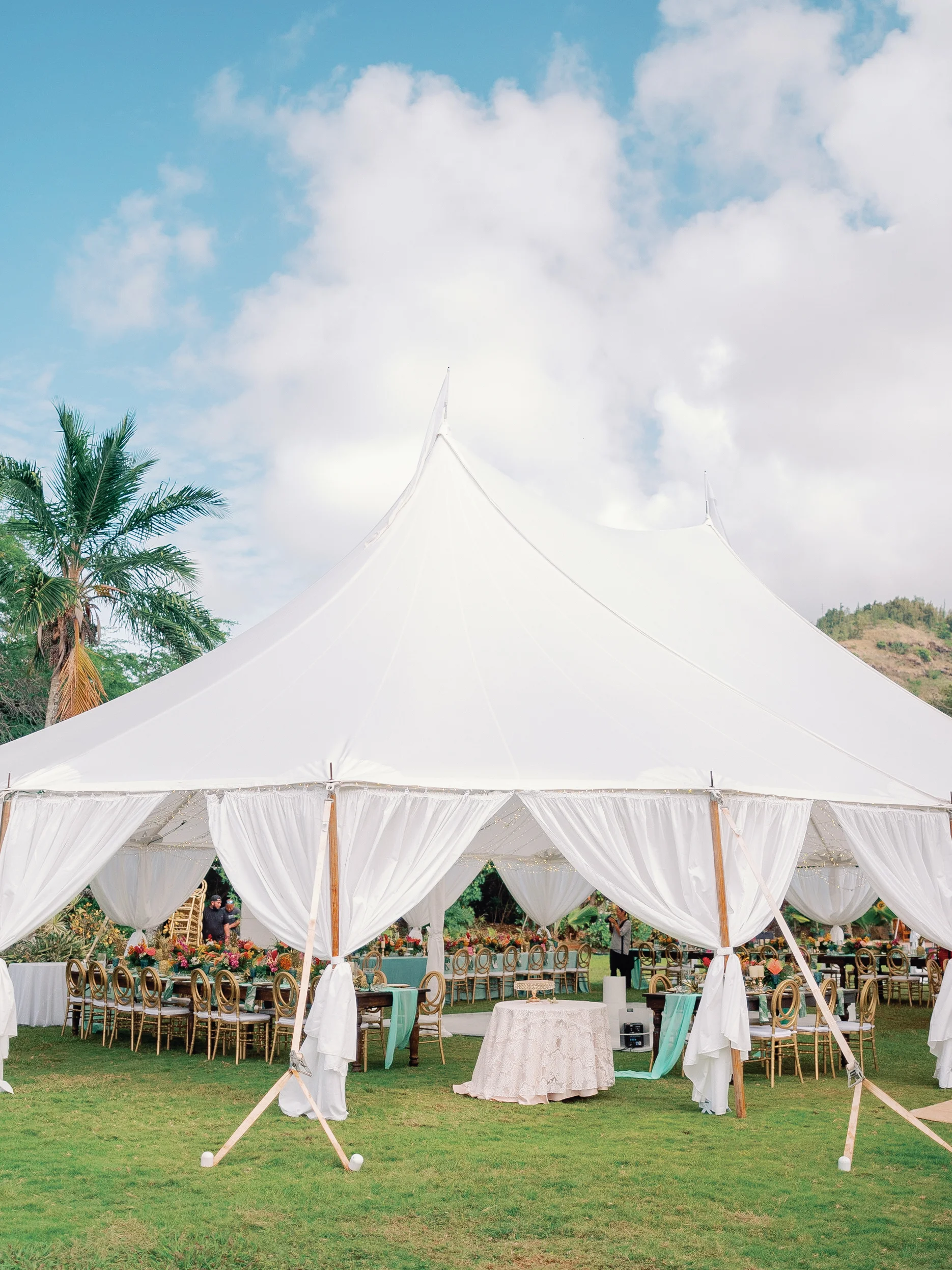 Elegant outdoor wedding setup under a white tent at Loulu Palms, Oʻahu, featuring luxurious floral arrangements and elegant seating. — Wedding Event Oahu Hawaii Florals Flowers Florist Creative Concepts by Jeff Alencastre