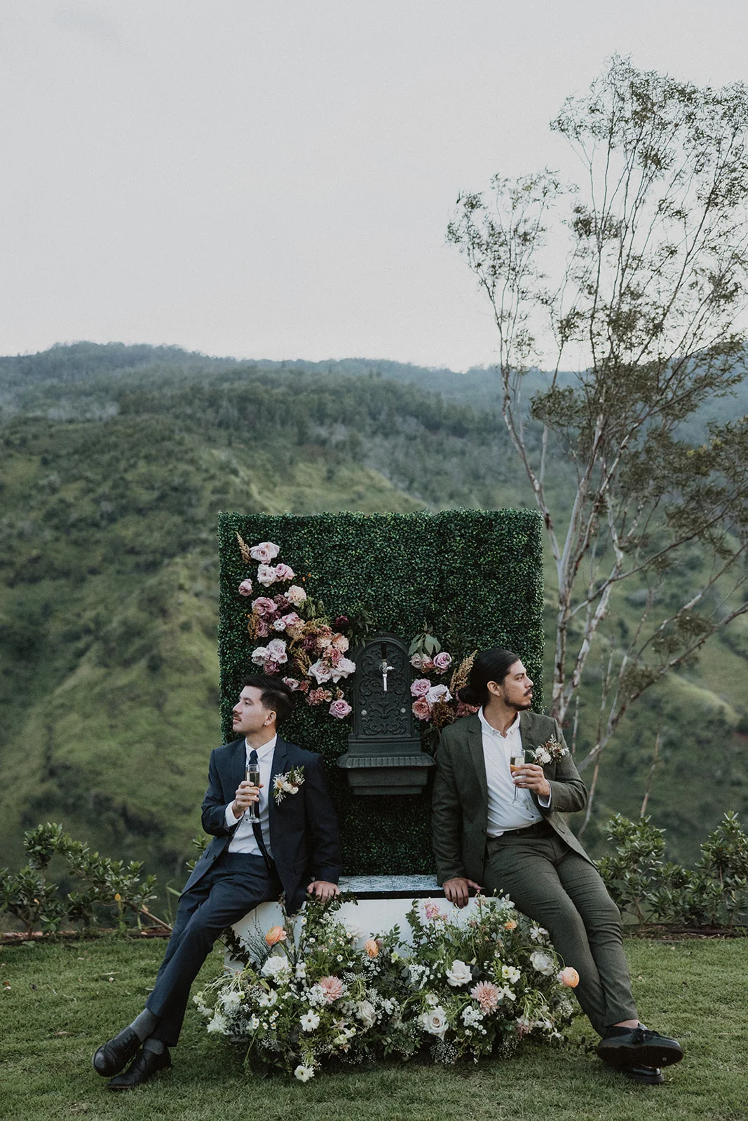 Elegant wedding floral arrangement with pink and white roses against lush greenery backdrop on Oʻahu.